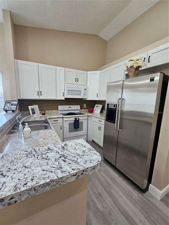 1025 Clovercrest Road Orlando, FL 32811 - Photo 9 of 27 a kitchen with granite countertop a refrigerator sink and stove