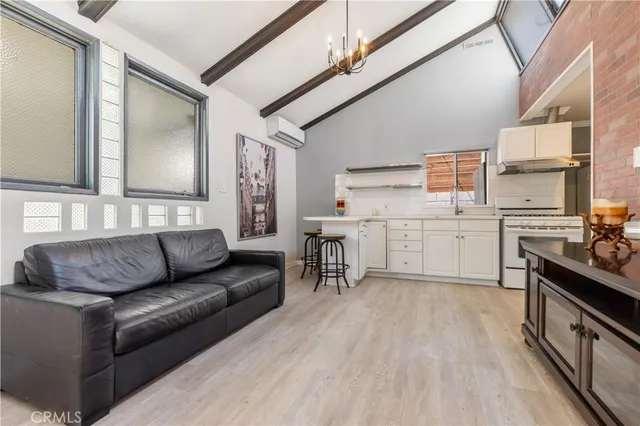 a kitchen with stainless steel appliances kitchen island wooden cabinets and a sink