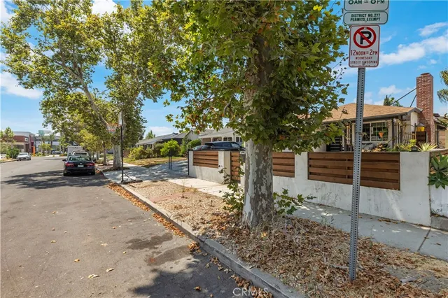 a street sign on a sidewalk next to a road