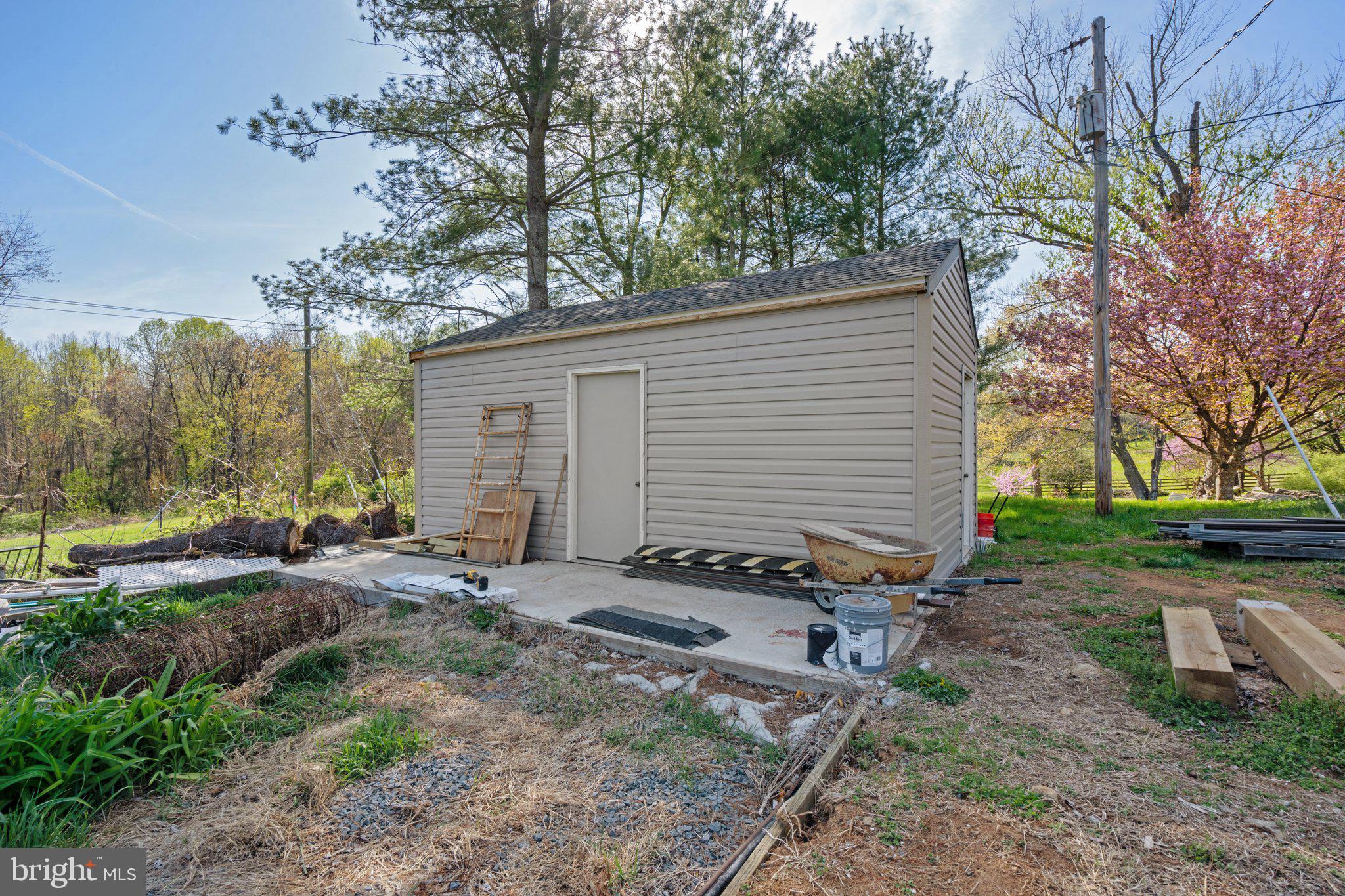 571 Richmond Road Amissville, VA 20106 - Photo 23 of 23 a backyard of a house with outdoor seating and trees