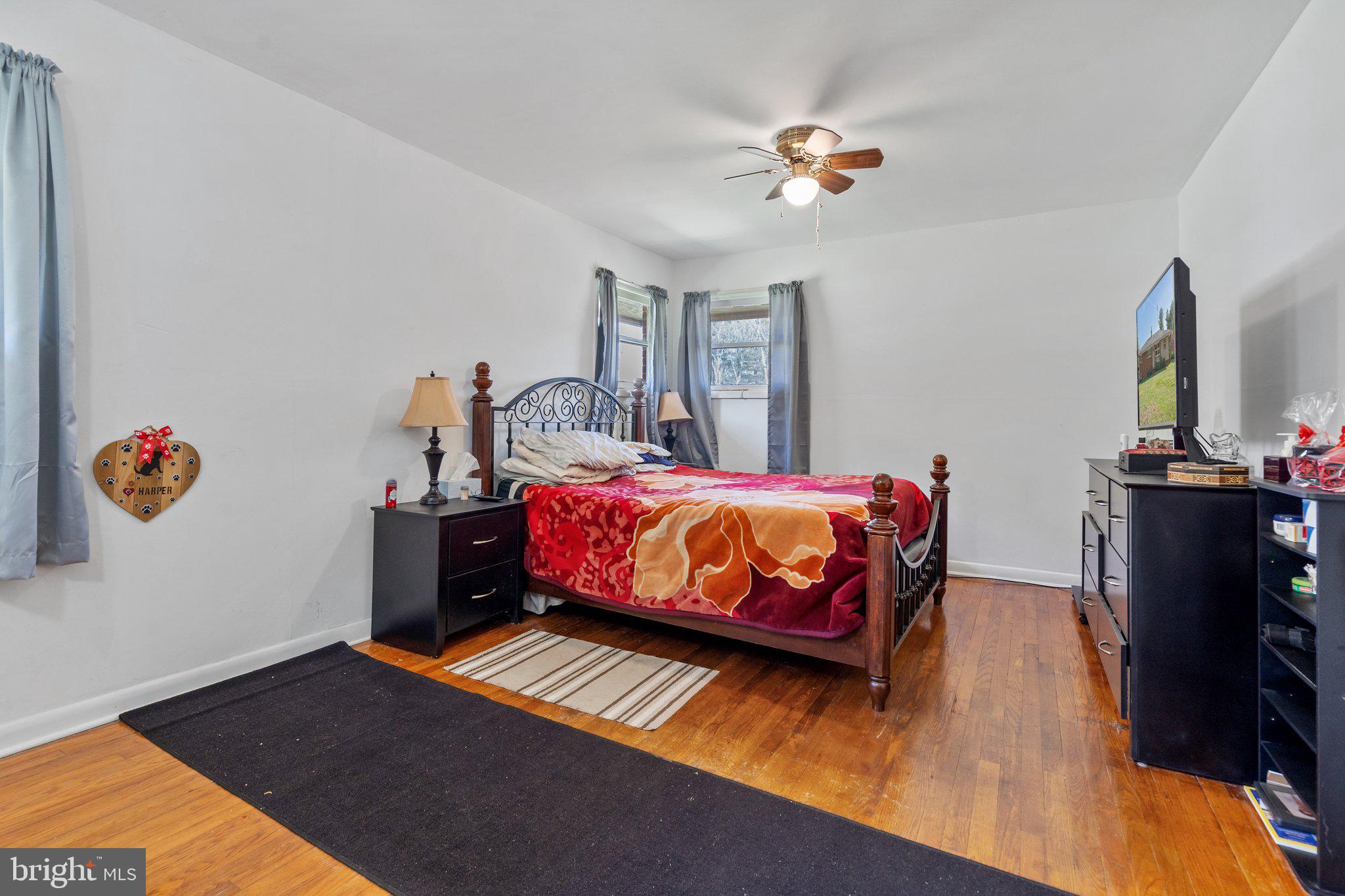 571 Richmond Road Amissville, VA 20106 - Photo 10 of 23 a bedroom with a bed and a chandelier