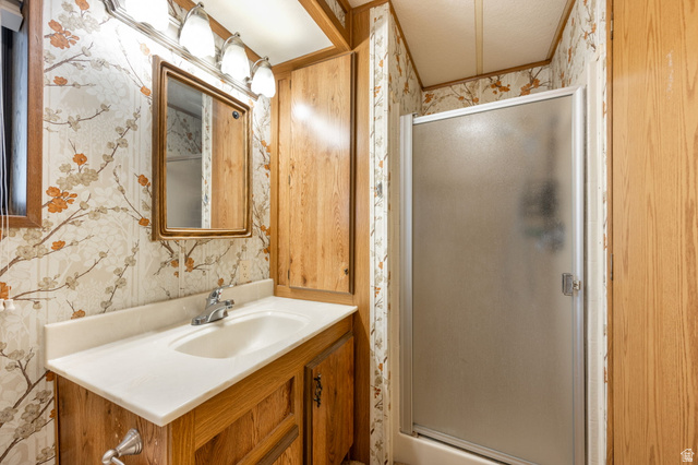 1360 North Dixie Downs Road, Unit 4 St. George, UT 84770 - Photo 19 of 22 Bathroom featuring a vanity with an integrated sink, a framed mirror, and an overhead four-bulb light fixture