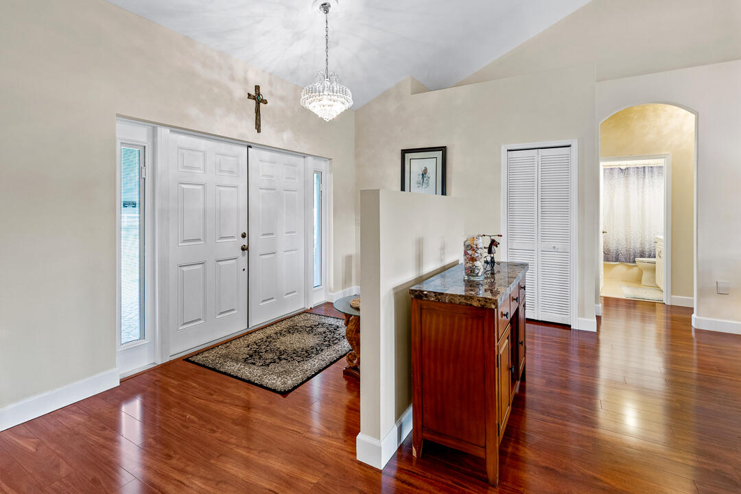 2774 Gentile Road Fort Pierce, FL 34945 - Photo 12 of 70 a view of a hallway with wooden floor and furniture