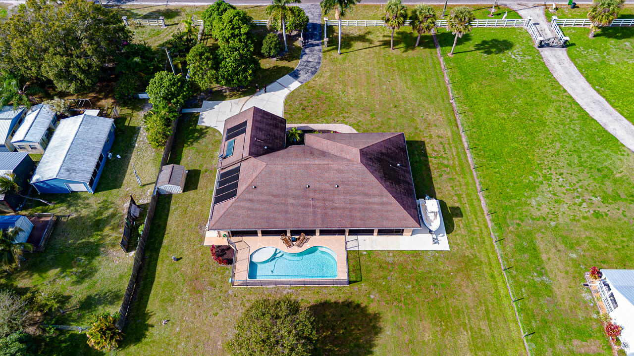 2774 Gentile Road Fort Pierce, FL 34945 - Photo 2 of 70 an aerial view of residential houses with outdoor space and swimming pool