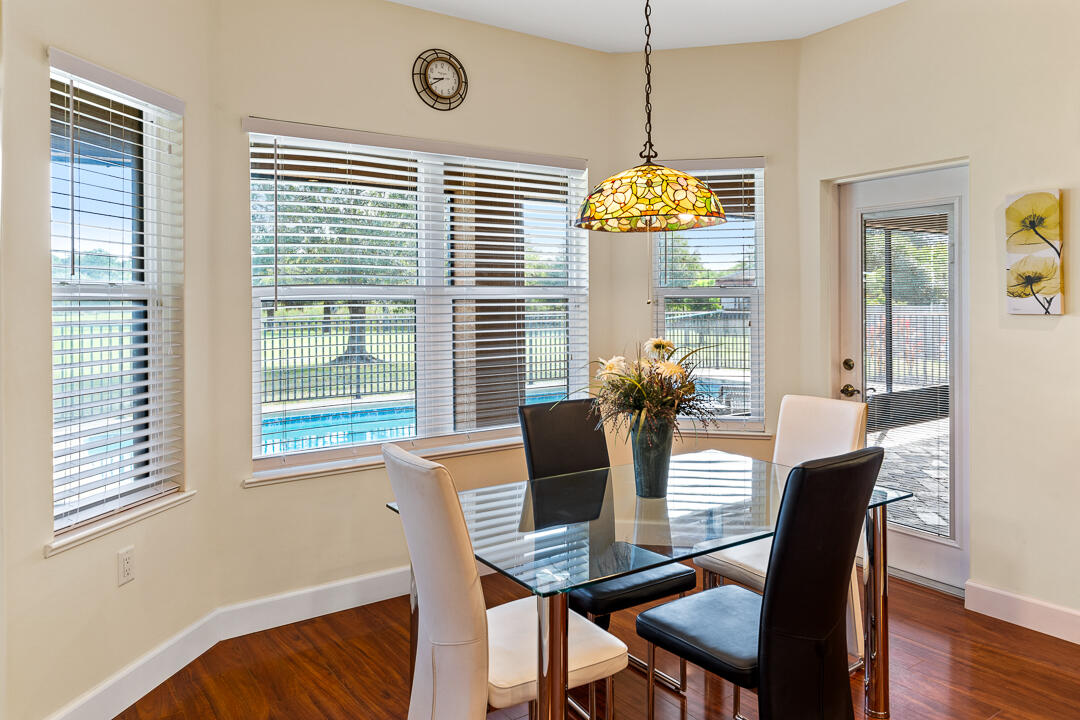 2774 Gentile Road Fort Pierce, FL 34945 - Photo 23 of 70 a view of a dining room with furniture wooden floor and chandelier
