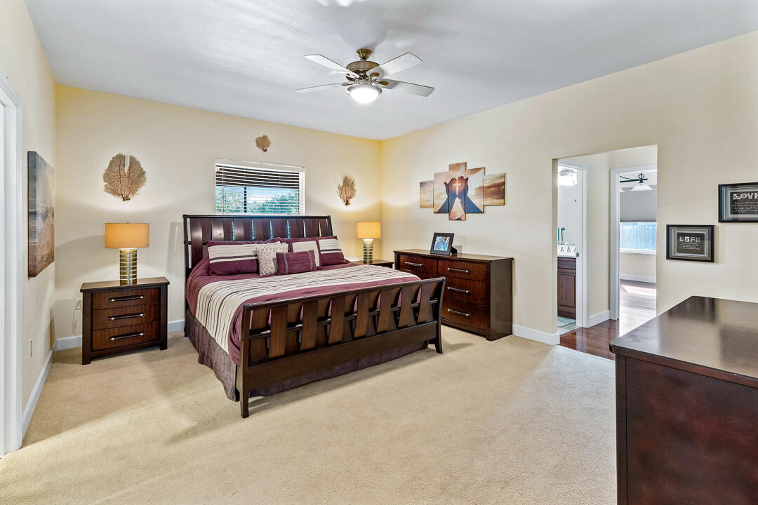 2774 Gentile Road Fort Pierce, FL 34945 - Photo 31 of 70 a bedroom with a bed and a chandelier