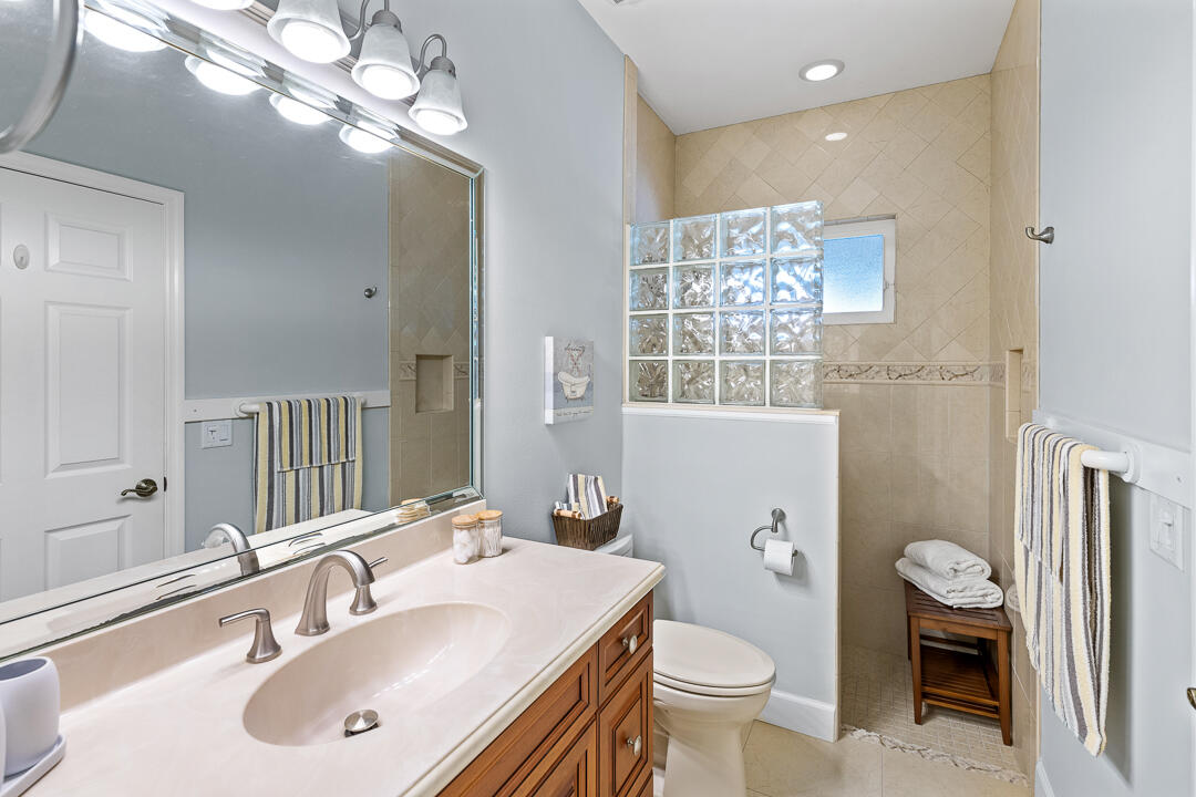 2774 Gentile Road Fort Pierce, FL 34945 - Photo 34 of 70 a bathroom with a sink a toilet and a mirror