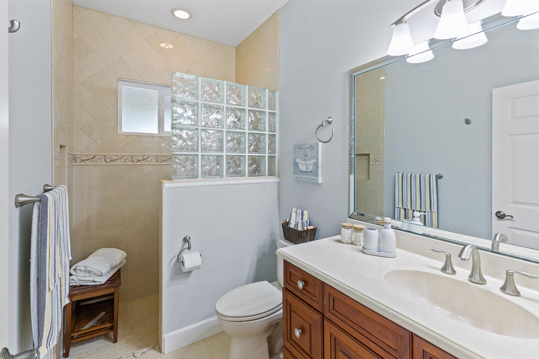 2774 Gentile Road Fort Pierce, FL 34945 - Photo 35 of 70 a bathroom with a granite countertop toilet sink and mirror