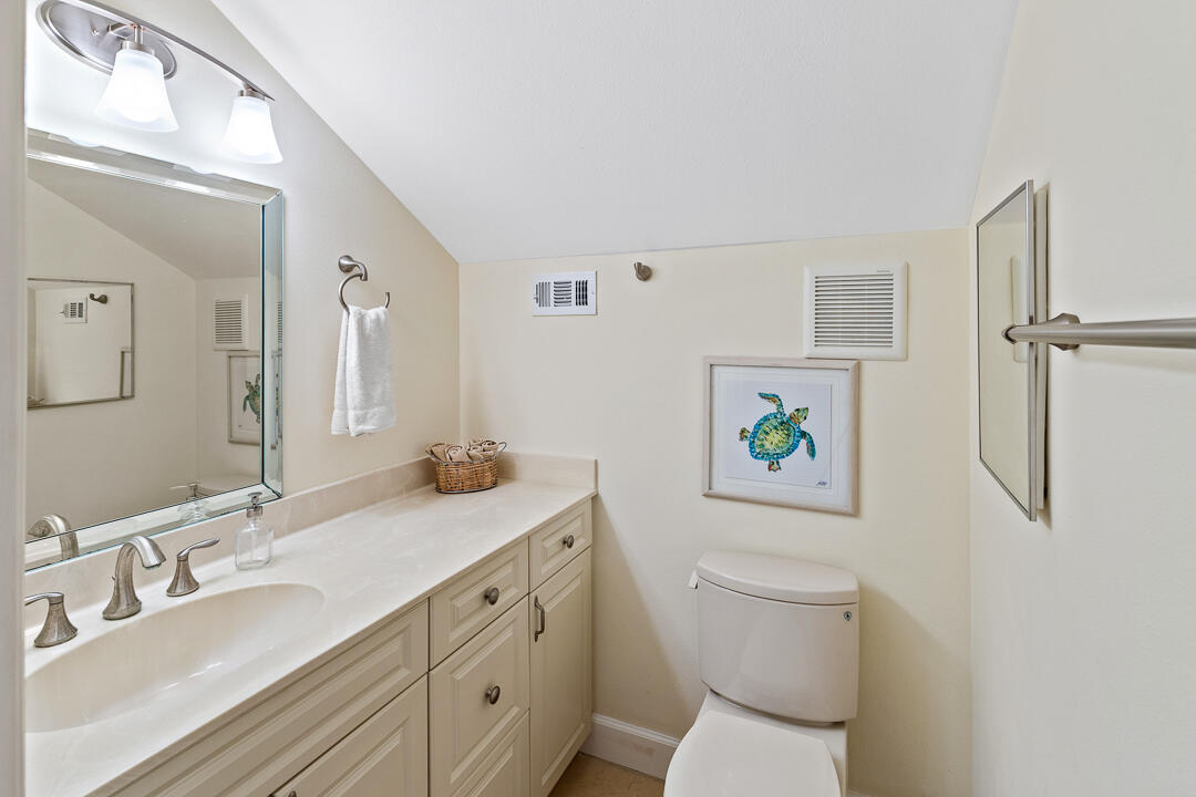 2774 Gentile Road Fort Pierce, FL 34945 - Photo 41 of 70 a bathroom with a granite countertop sink toilet and a mirror