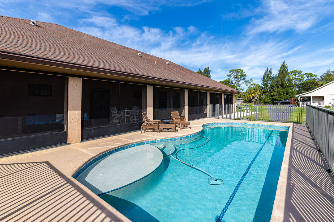 2774 Gentile Road Fort Pierce, FL 34945 - Photo 47 of 70 a view of a house with pool and a yard
