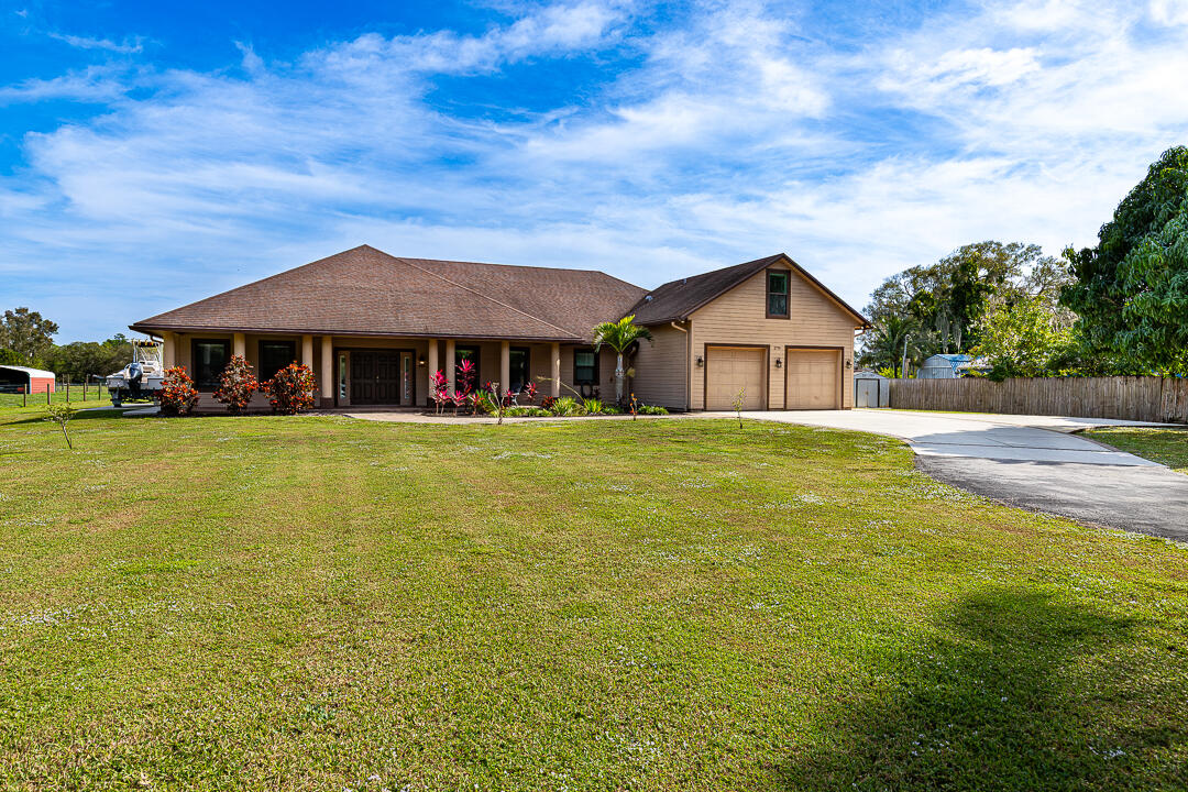 2774 Gentile Road Fort Pierce, FL 34945 - Photo 59 of 70 a front view of a house with yard and green space