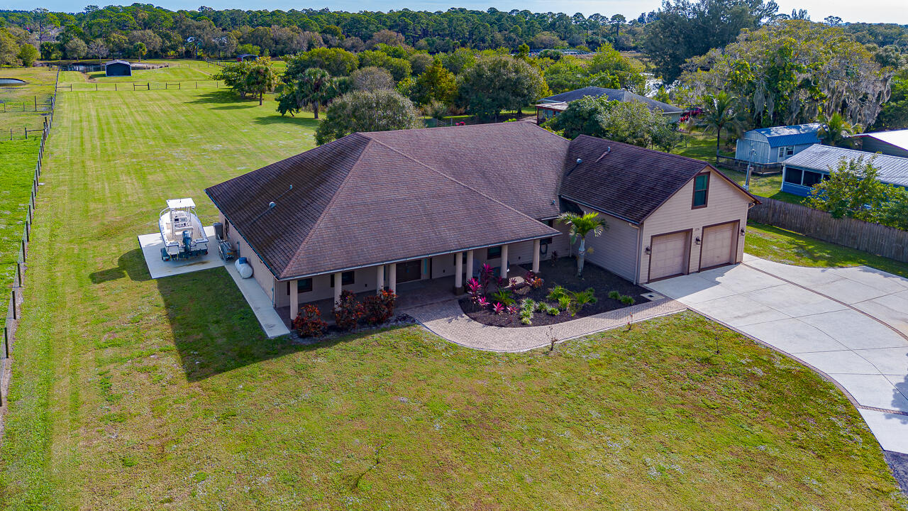 2774 Gentile Road Fort Pierce, FL 34945 - Photo 69 of 70 an aerial view of house with yard and lake view