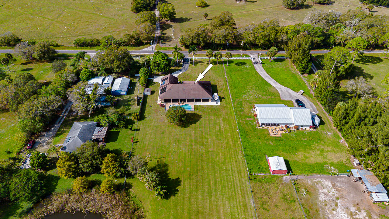 2774 Gentile Road Fort Pierce, FL 34945 - Photo 7 of 70 an aerial view of a house with a swimming pool