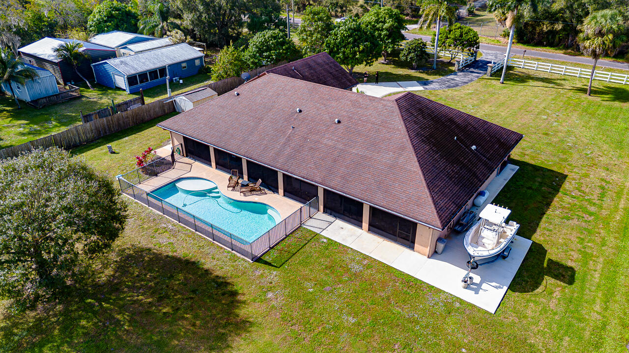 2774 Gentile Road Fort Pierce, FL 34945 - Photo 9 of 70 an aerial view of a house with swimming pool