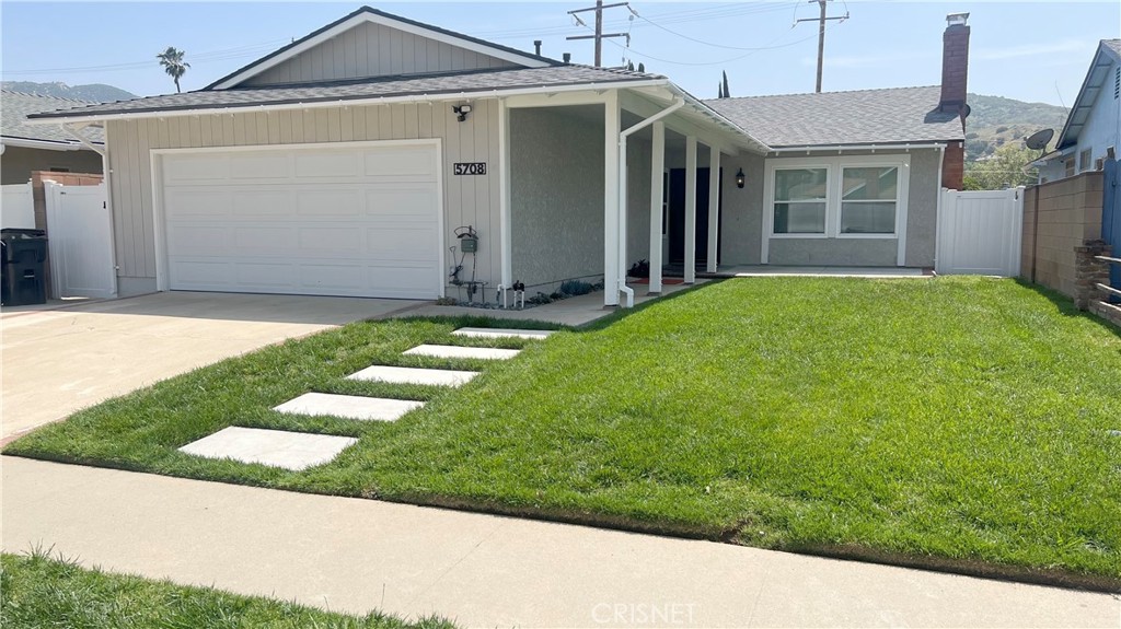 5708 Damon Street Simi Valley, CA 93063 - Photo 1 of 23 a front view of a house with a yard and garage