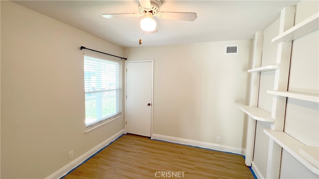 5708 Damon Street Simi Valley, CA 93063 - Photo 16 of 23 a view of an empty room with wooden floor and a window