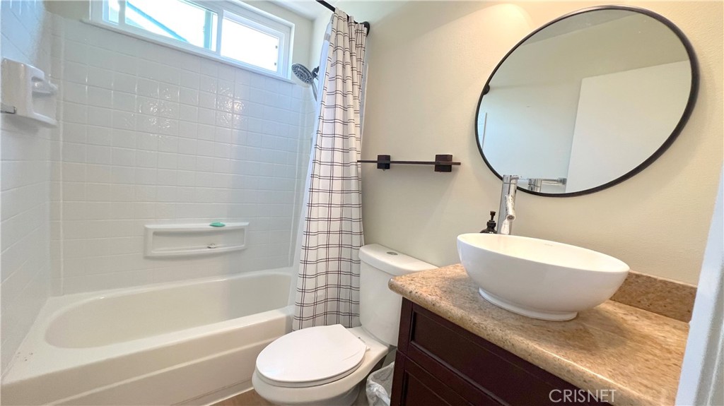 5708 Damon Street Simi Valley, CA 93063 - Photo 17 of 23 a bathroom with a granite countertop toilet a sink and bathtub