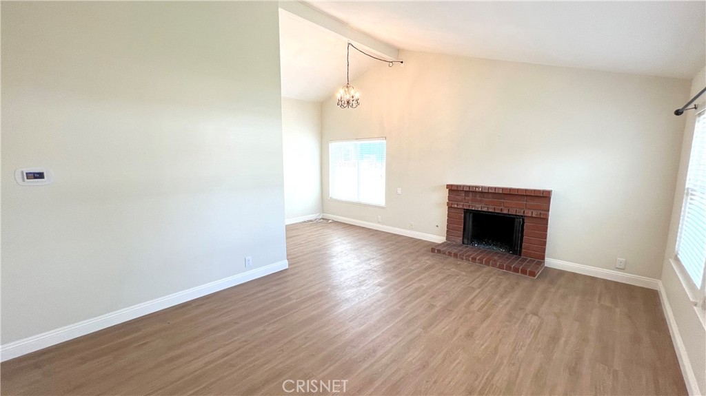 5708 Damon Street Simi Valley, CA 93063 - Photo 3 of 23 an empty room with wooden floor and fireplace