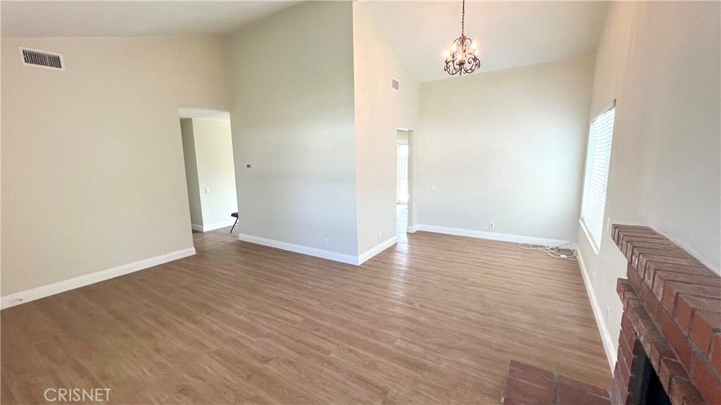 5708 Damon Street Simi Valley, CA 93063 - Photo 4 of 23 an empty room with wooden floor and windows