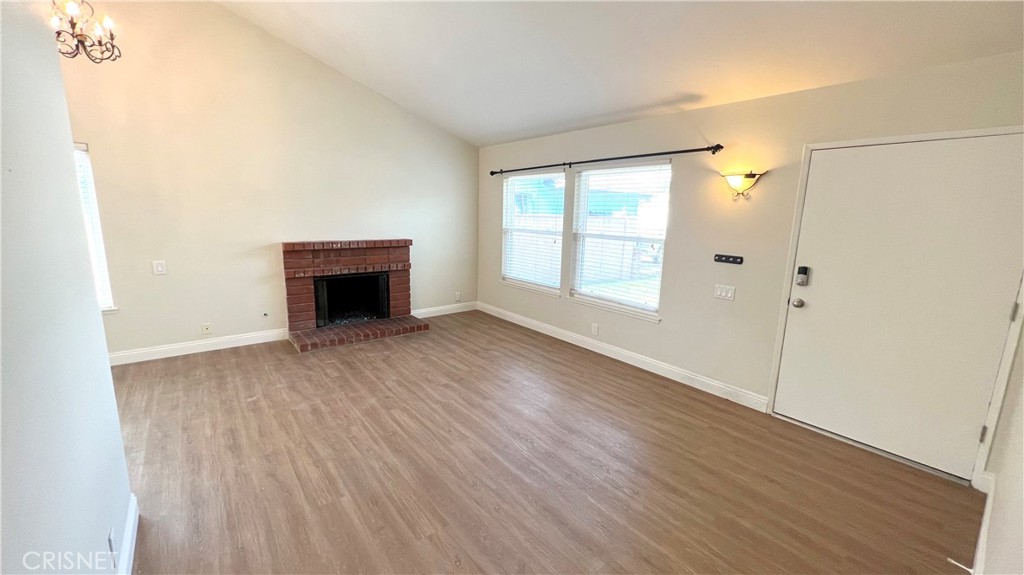 5708 Damon Street Simi Valley, CA 93063 - Photo 5 of 23 an empty room with wooden floor and a fireplace