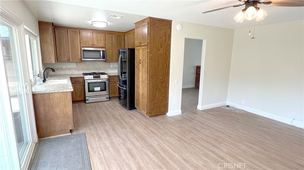 5708 Damon Street Simi Valley, CA 93063 - Photo 7 of 23 a kitchen with granite countertop a refrigerator stove and sink