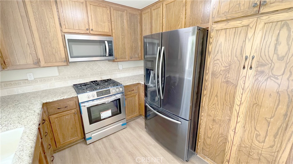 5708 Damon Street Simi Valley, CA 93063 - Photo 10 of 23 a kitchen with a refrigerator sink and microwave