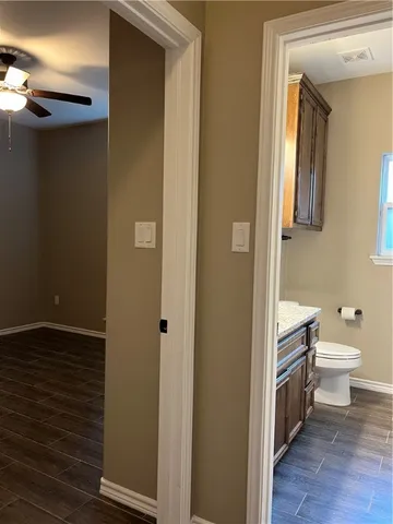 a bathroom with a toilet and a shower