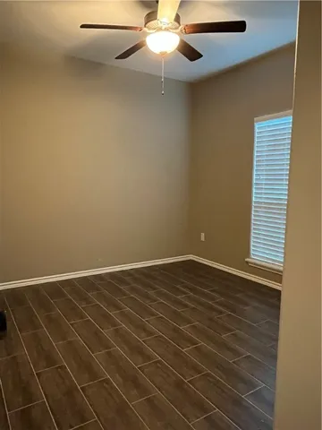 a view of an empty room with a chandelier fan