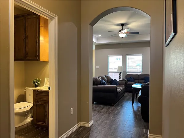 a living room with furniture and a toilet