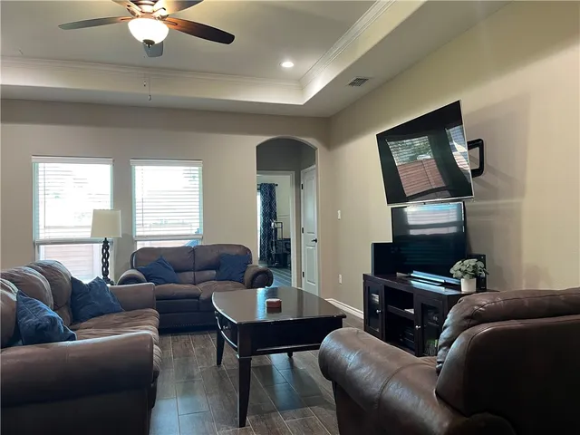 a living room with furniture and a flat screen tv