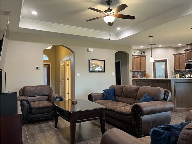 a living room with furniture and a chandelier