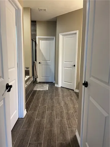 a view of a bathroom from a hallway