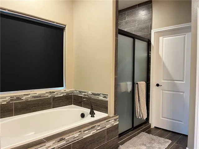 a bathroom with a tub and a sink