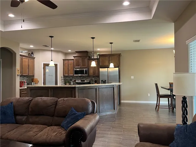 a living room with furniture and kitchen view