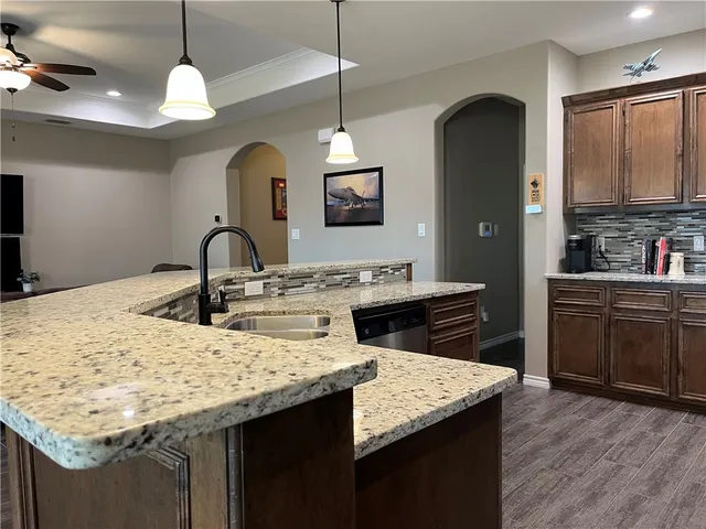 a kitchen with sink stove and kitchen island