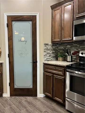 a kitchen with granite countertop stainless steel appliances and cabinets