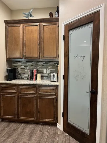 a kitchen with stainless steel appliances granite countertop a stove a sink and a refrigerator with wooden floor