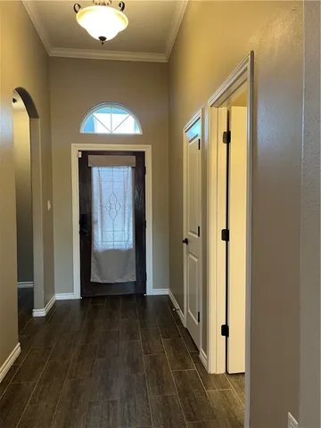 a view of a hallway with wooden floor and closet