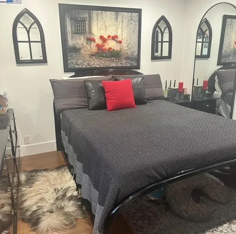 a bedroom with a bed and a chandelier