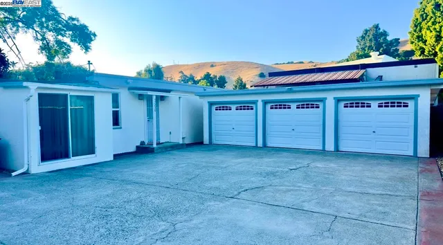a kitchen with stainless steel appliances kitchen island granite countertop a refrigerator and a sink