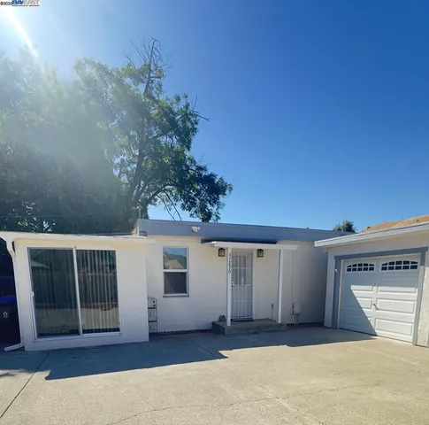 a bedroom with a bed and a potted plant