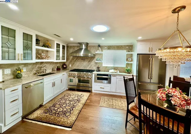 a view of a dining room with furniture wooden floor and chandelier