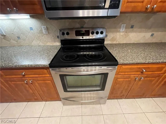 a stove top oven sitting inside of a kitchen