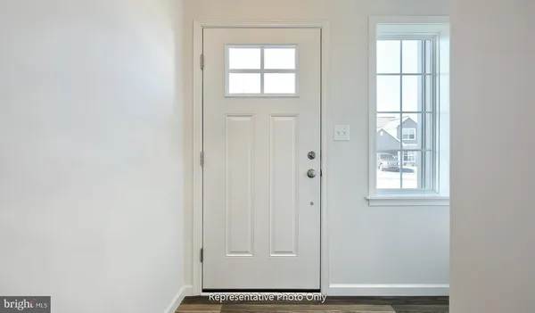 a view of an entryway with wooden floor