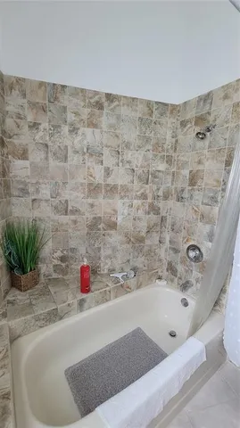 a bathroom with a tub sink and a shower