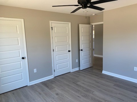 122 Pisgah Ridge Road Pulaski, TN 38478 - Photo 8 of 16 an empty room with wooden floor closet and windows