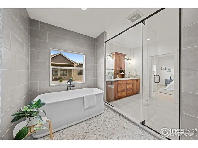 a bathroom with a tub shower and sink