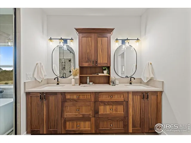 a bathroom with a double vanity sink and a mirror