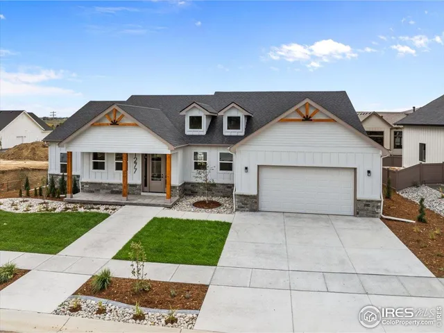 a front view of a house with a garden and plants