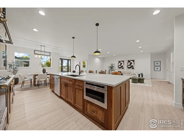 a kitchen with stove and wooden floor